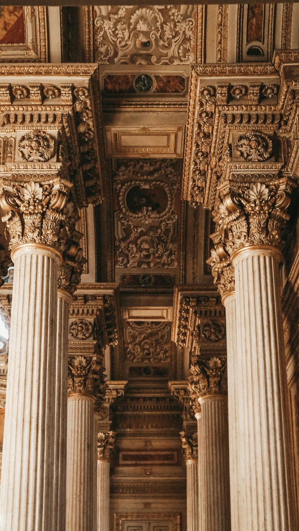 Gilded baroque columns and a painted ceiling