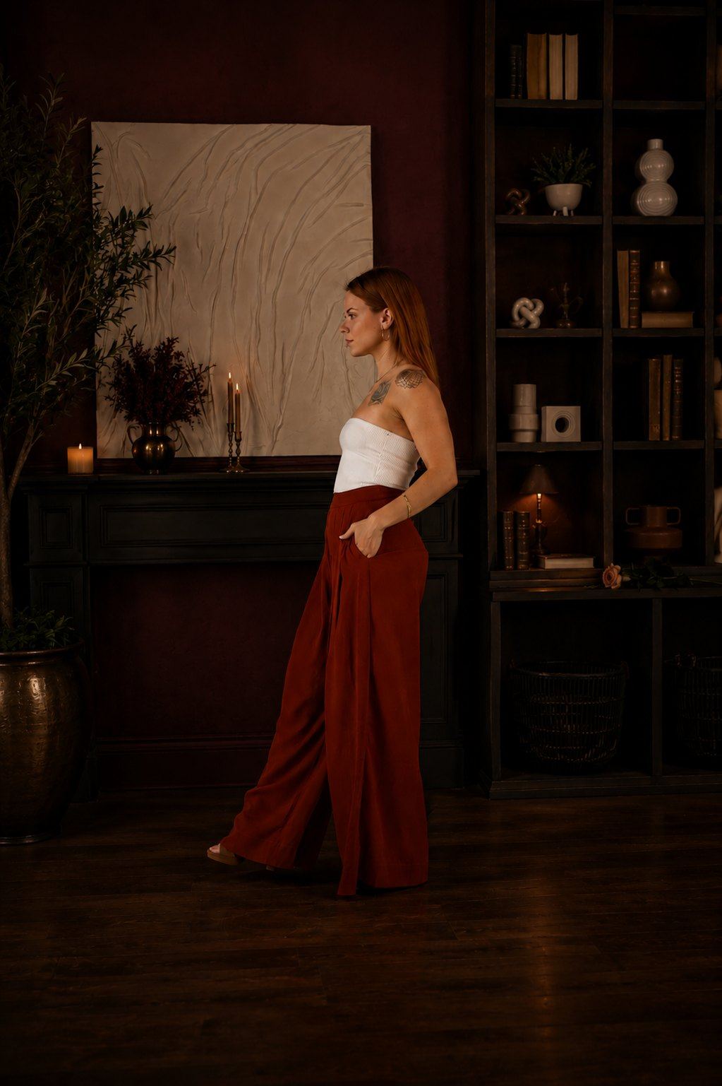 Olivia Carli walking through a candlelit room